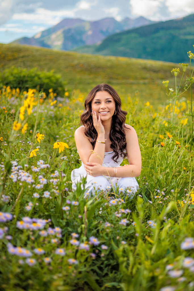 high school senior posed in Colorado wildflower field