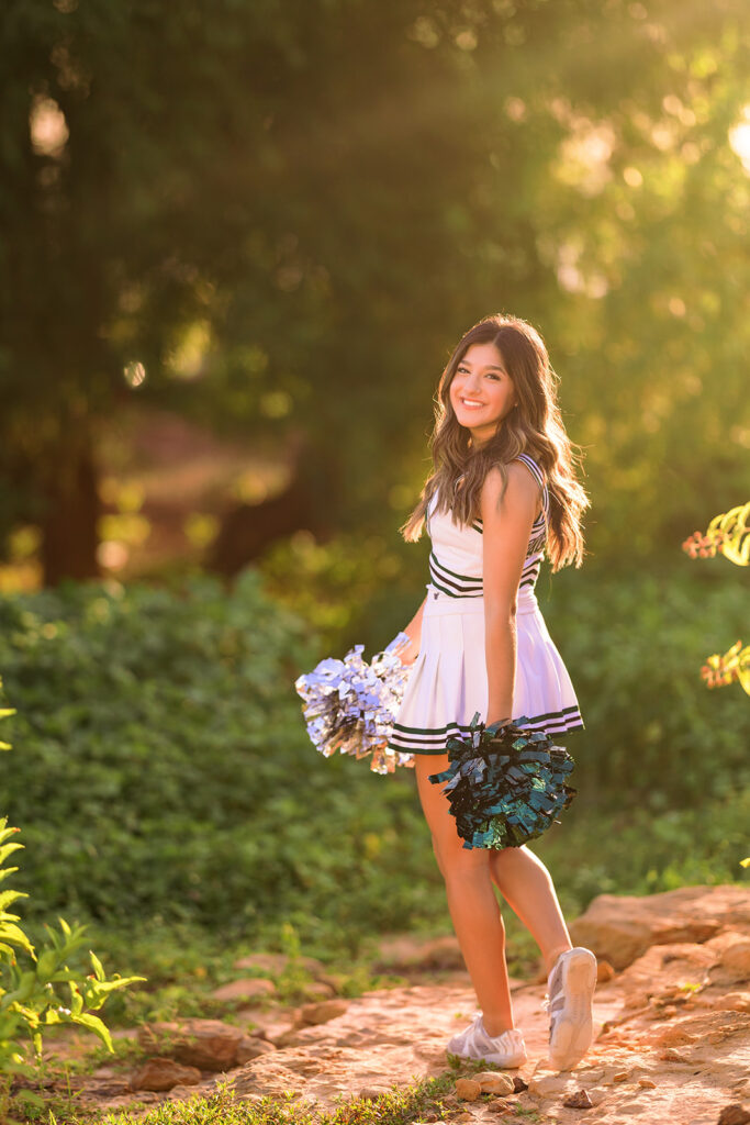high school senior wearing cheerleading outfit for senior portraits